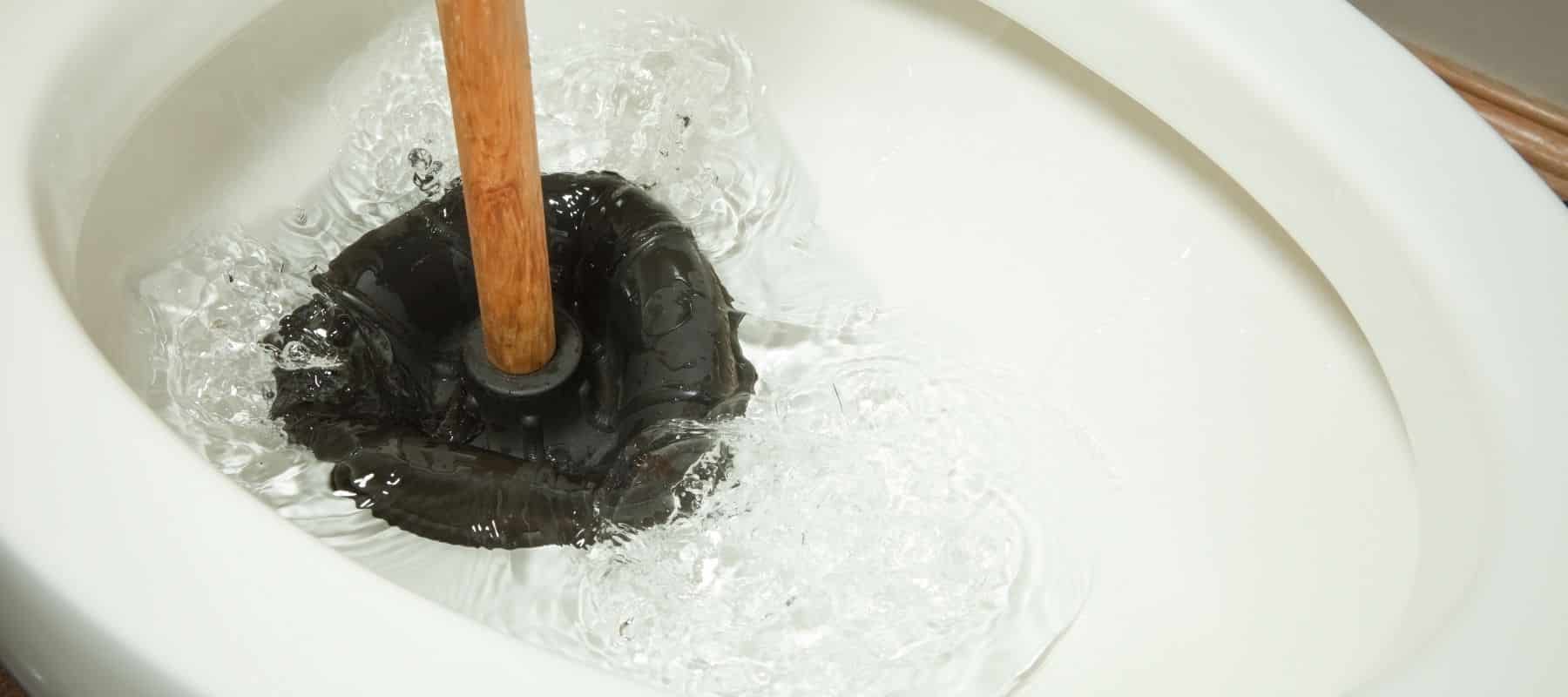 plunger under water in toilet bowl