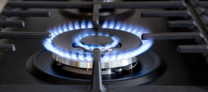 closeup of a gas stove being turned on